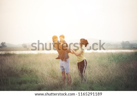 Happy Asian Family enjoying family time together in the park. Family Concept