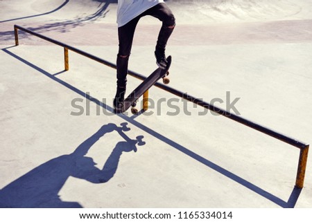 Skateboarder doing a trick in a skate park, practice freestyle extreme sport 