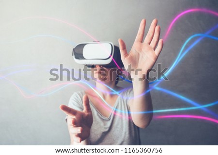 Woman using VR headset. Conceptual mixed media image of female person immersed in virtual reality.