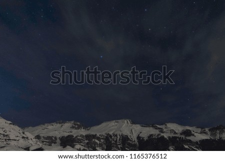 Galaxy, mountains, stars, clouds and snow in a night photo session at the mountains in Santiago, Chile