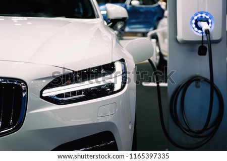 Power supply for hybrid electric car charging battery. Eco car concept. Royalty-Free Stock Photo #1165397335