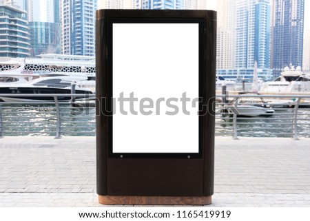 Empty outdoor digital signage light box with lake background and yachts  Ideal for digital advertisement, information board, mall ads, video wall and large posters for campaigns.