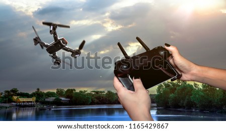 Drone Technology Is controlled by remote control concept . Pocket spy Foldable Drone quadrocopter, with high resolution digital camera flying aerial over spectacular at sunset During travel.