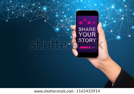Share your story concept. Share your story on smartphone screen in businesswoman hand.