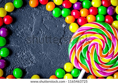 sweets and sugar candies on dark background top view