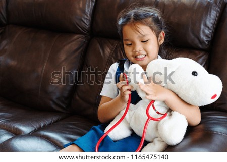 little girl are smiling and playing doctor with stethoscope. Kid and health care concept.