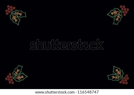 Christmas holly decoration against a black background.