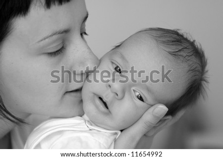 Loving mother and her small newborn, black-white