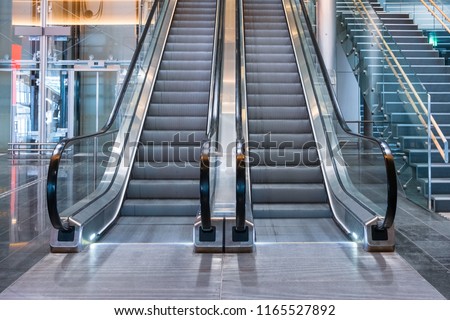 Modern luxury escalators with staircase at airport Royalty-Free Stock Photo #1165527892