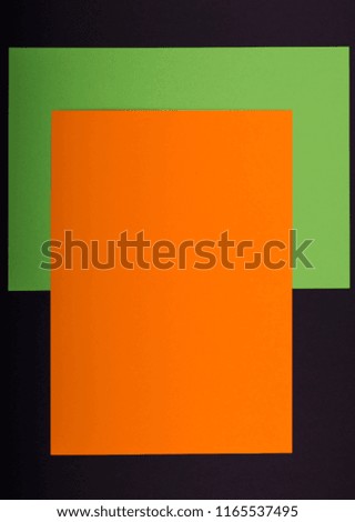 Colorful paper background with orange, green, black paper for handcraft Halloween composition. Place under text. Unfocused view