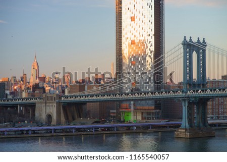 Manhattan Downtown skyline panorama with manhattan bridge foreground from Brooklyn Bridge Park riverbank