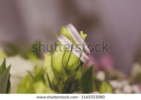 White gold wedding rings on wedding flower