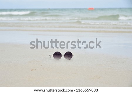 Sunglass on sand beach , area for copy space.