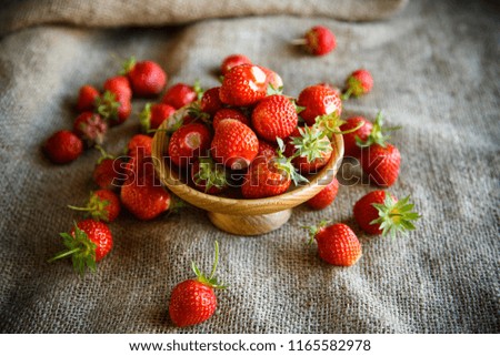 ripe red strawberry on a table with burlap