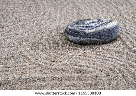 Zen composition. Garden of stones.Calming patterns on the sand.
