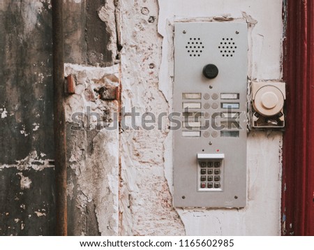 Old inter com ring bell access home. Weathered retro grunge wall. Move address sing call. Europe street doorbell.