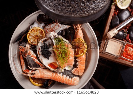Seafood on hot stones with fish broth with lemongrass, kafir lime and orange.