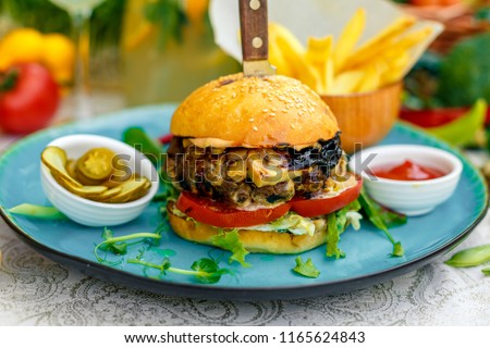 cheese mushroom burger with french fries jalapeno and sauce, outside