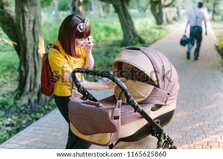 walking Mother with baby carriage