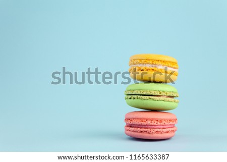 Colorful cake macaron or macaroon on blue pastel background. Different types of macaroons. copy space for text.