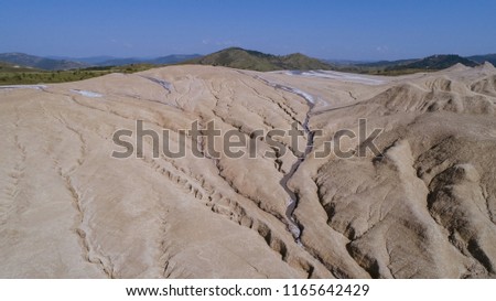 Aerial view of a geological and botanical reservation with mud volcanoes on a sunny day.