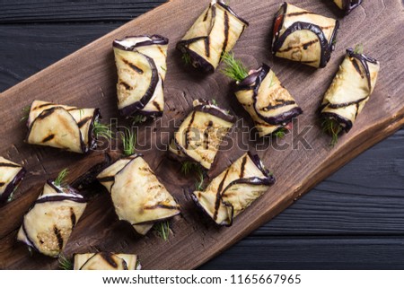 Grilled eggplant ( aubergine ) rolls with cream cheese and tomatoes