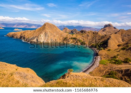Aerial view of the northern part of Pulau Padar island in between Komodo and Rinca Islands with blue sea water.