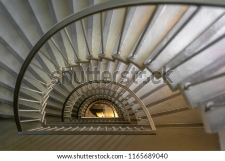 A staircase winding down a building