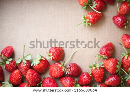 Fresh strawberries on cardboard background with copy space. Top view.