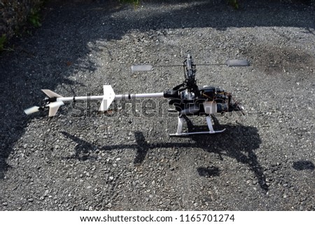 Radio controlled helicopter model before take-off with the engine running. Blurred focus in the field of moving parts of the helicopter.