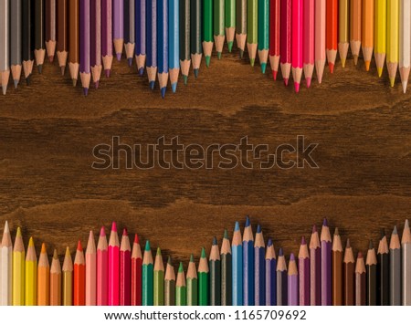 Colored pencils on wooden table