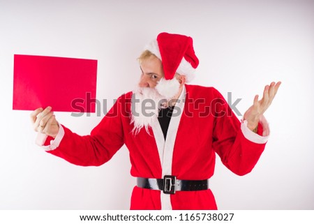 Santa Claus with a sign on a white background. The concept of discounts and sales for Christmas. Empty space for text     