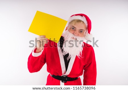 Santa Claus with a sign on a white background. The concept of discounts and sales for Christmas. Empty space for text     