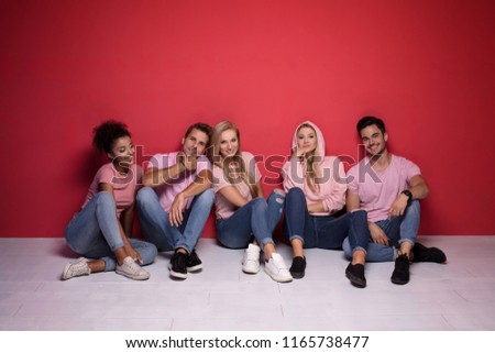 Young multi-ethnic attractive people smiling and spending time together, posing on colorful background.