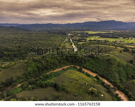 Top View of Rural Road, Path through the green forest and countryside of Thailand, Top view aerial photo from drone.