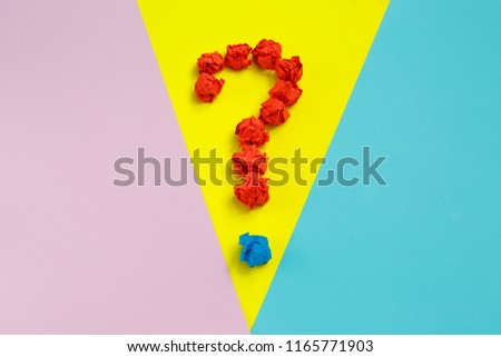 Red question mark lined with crumpled paper balls oncolorful background top view copy space. Asking, Decisions. FAQ concept. Concept ideas. Flat lay.