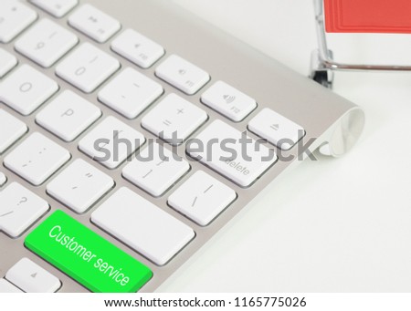 green Customer service message on keyboard with model shopping cart for concepts of admiration, Compliment