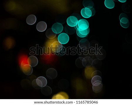 Abstract photo of backlight reflector and glitter bokeh lights background. Image is blurred and made with colorful filters. 