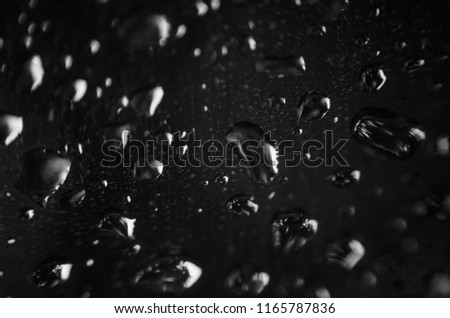 Water drops after the rain in a dark window