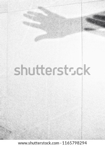 Blurred image : Silhouette or Shadow of scared woman's hand was pulled by another hand on white floor tiles background, Haunt and Horror theme. Halloween theme