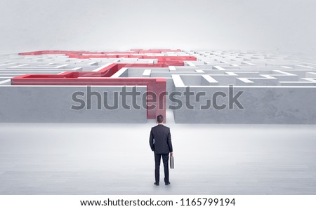 Businessman getting ready to enter the labyrinth with stated road concept