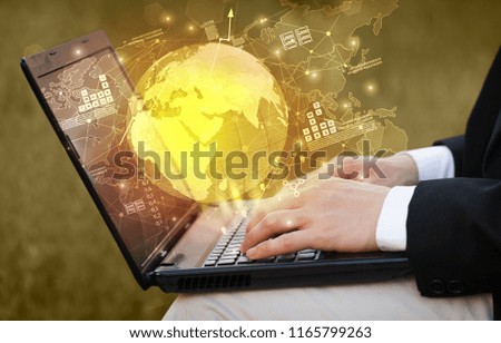 Hand using laptop with global reports and stock market change concept