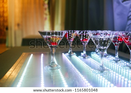 coctail with cherry on neon table