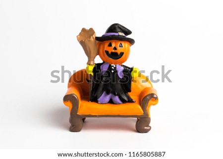 Wizard pumpkin  halloween standing on a orange sofa on a white background.