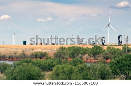Typical landscape of Texas: endless fields, wind generators, oil pumps, rare green bushes