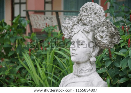 decorted stone chinese female statue in the garden