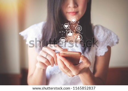 Asia woman using mobile phone for checking social media and success of business. Royalty-Free Stock Photo #1165852837