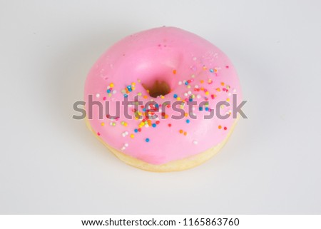 Isolated picture of doughnut with sweet cream topping and colorful sugar bead, popular dessert for kids and teenager that cause overweight problem lead to heart disease because of high dangerous fat
