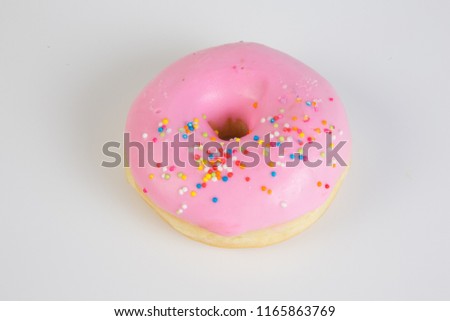 Isolated picture of doughnut with sweet cream topping and colorful sugar bead, popular dessert for kids and teenager that cause overweight problem lead to heart disease because of high dangerous fat