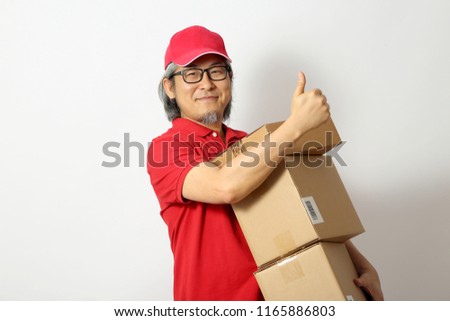 The Asian man dressed red polo shirt with red cap standing on the white background.